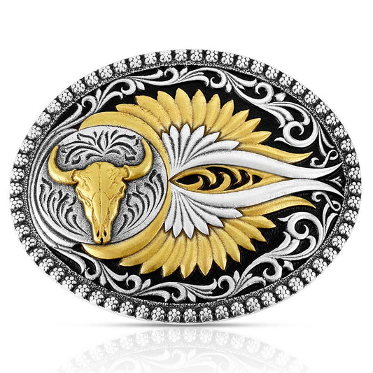 Decorative Montana Silversmiths belt buckle with gold bull skull and silver eye design on a black background