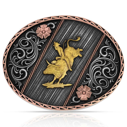 Decorative Montana Silversmiths belt buckle with gold bull and floral designs on a black background