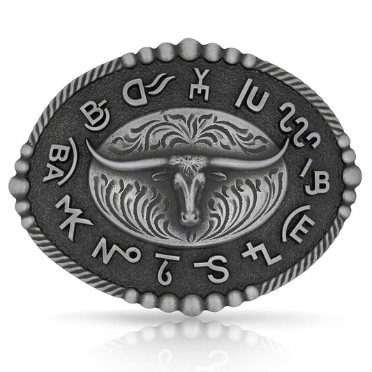 Metallic Montana Silversmiths belt buckle with bull design and engraved text on a white background