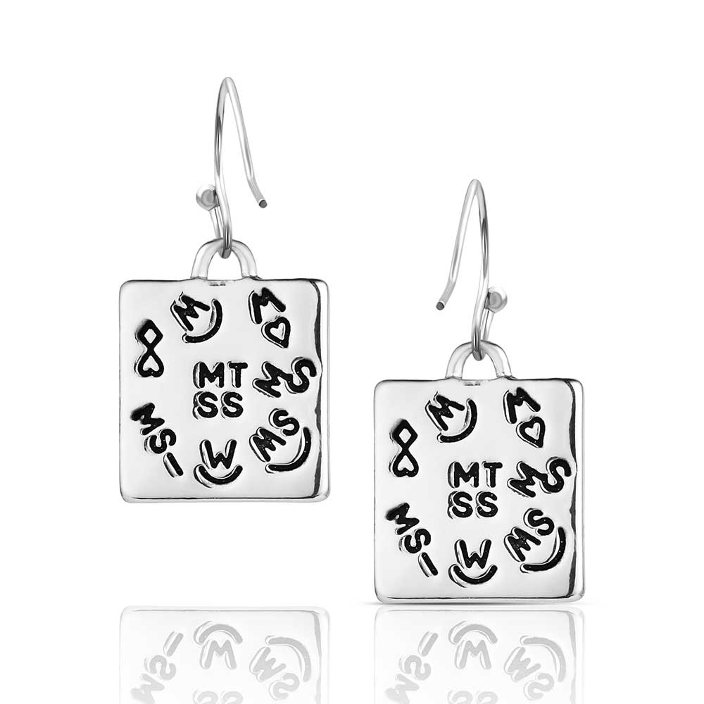 Pair of Montana Silversmiths earrings with square design featuring engravings on a white background
