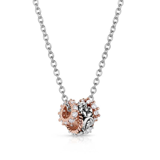 Montana Silversmiths Necklace with a rose gold and silver pendant on a white background