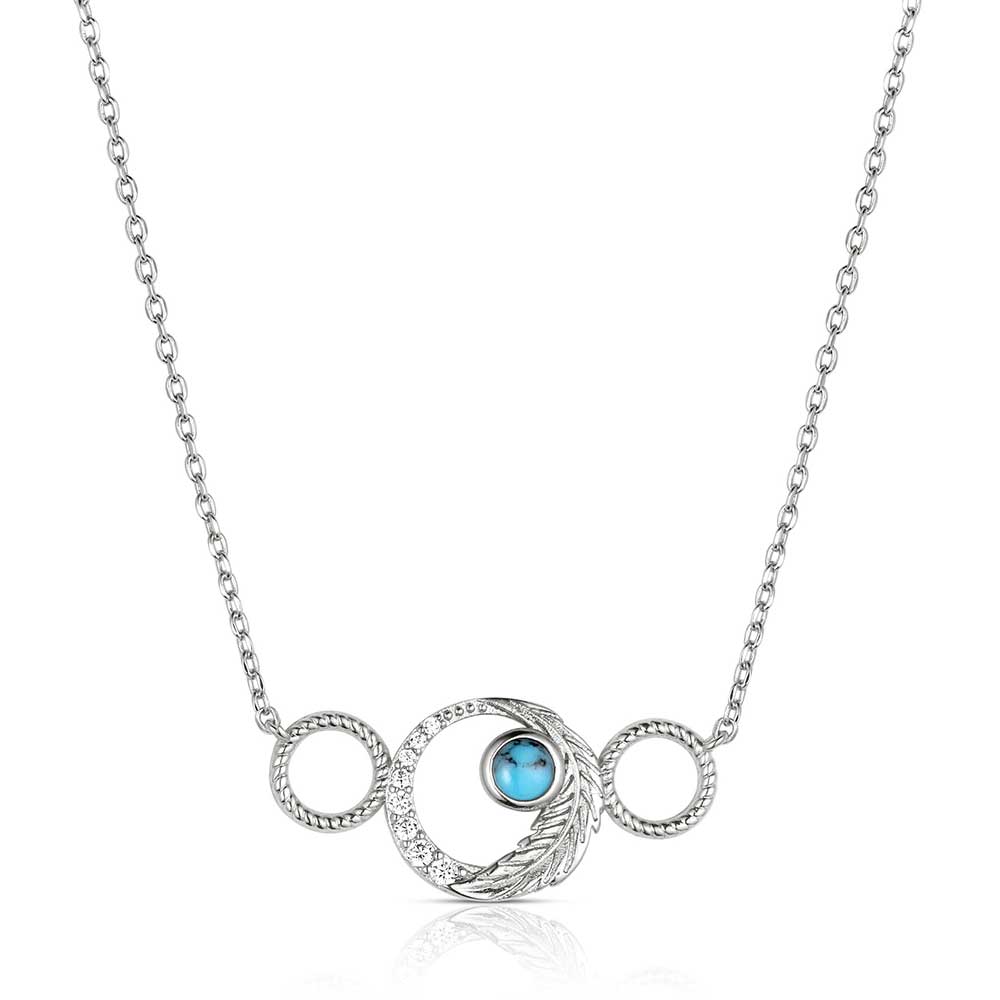 Montana Silversmiths Silver necklace with a circular pendant featuring a blue gemstone on a white background