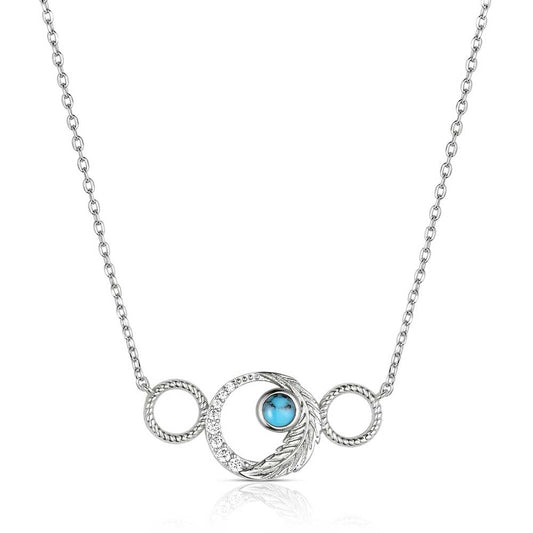 Montana Silversmiths Silver necklace with a circular pendant featuring a blue gemstone on a white background