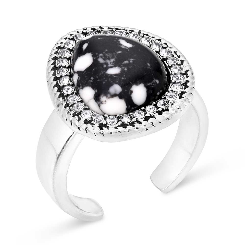 Silver Montana Silversmiths ring with a black and white stone on a white background