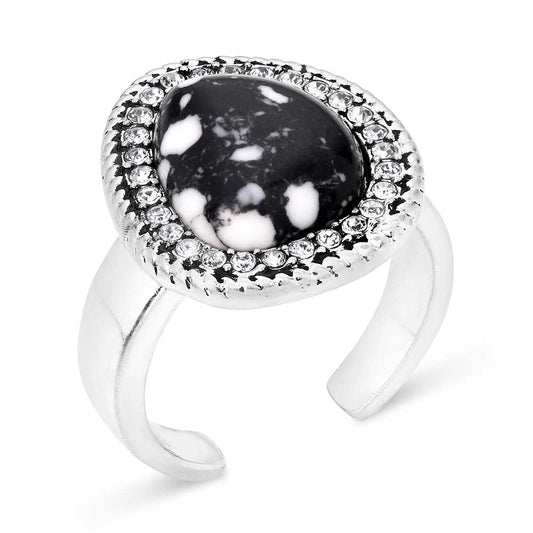 Silver Montana Silversmiths ring with a black and white stone on a white background