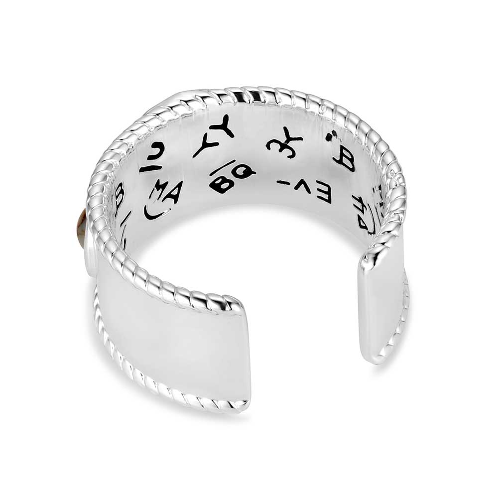 Silver Montana Silversmiths ring with engraved text on a white background