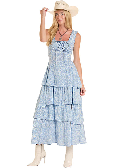 Girl wearing a blue Rock&Roll Denim dress, white boots and a cowboy hat on a white background