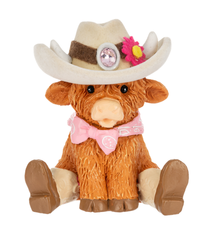 a small cow figurine from Ganz wearing western wear on a white background