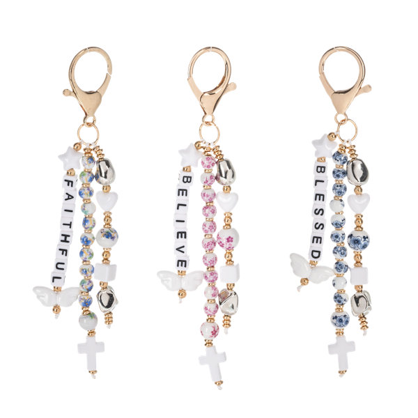 Bag charms from Ganz with inspirational words, beads and clips. On a white background