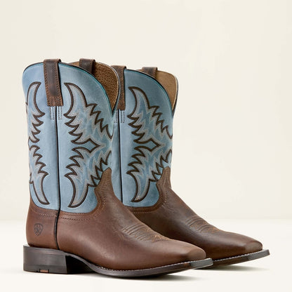 Pair of brown and blue Ariat cowboy boots on a light beige background