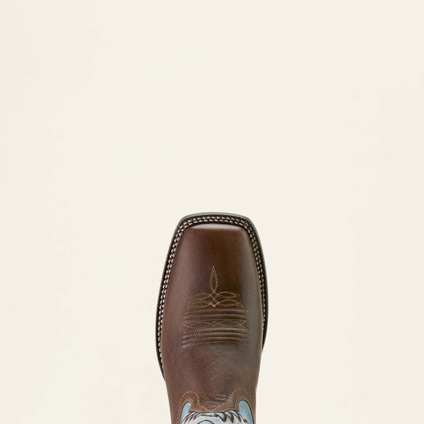 Brown leather Ariat boot with intricate stitching on a beige background