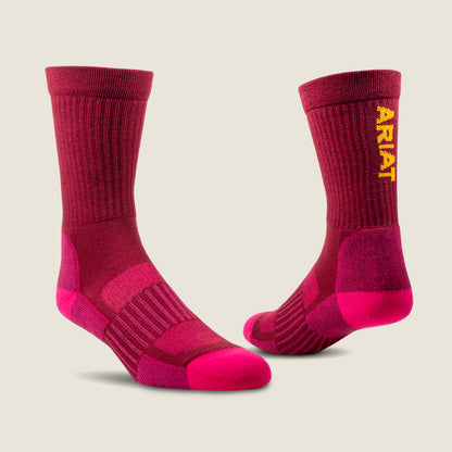 Pair of  pink socks with 'Ariat' branding on a beige background