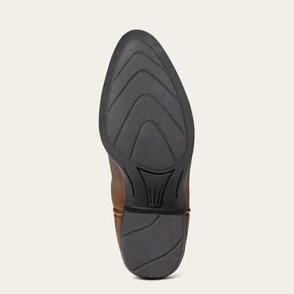 A close-up view of the black treaded outsole of a brown Ariat boot, shown from a top-down perspective against a light beige background.