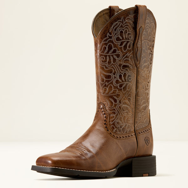 Brown Ariat cowboy boot with intricate embossing on a white background