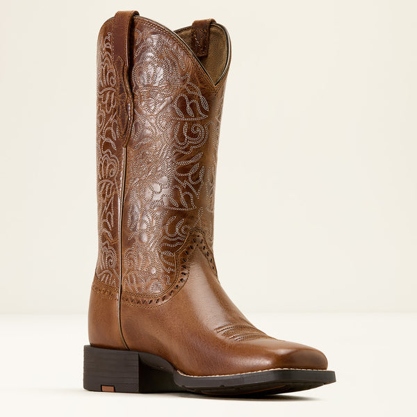 Brown Ariat cowboy boot with intricate embossing on a white background