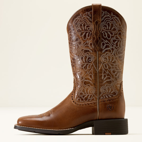 Brown Ariat cowboy boot with intricate embossing on a white background