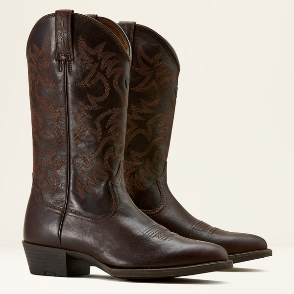 Pair of brown leather Ariat cowboy boots on a cream background