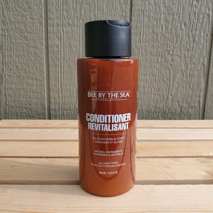 a brown bottle of bee by the sea conditioner on a wooden background