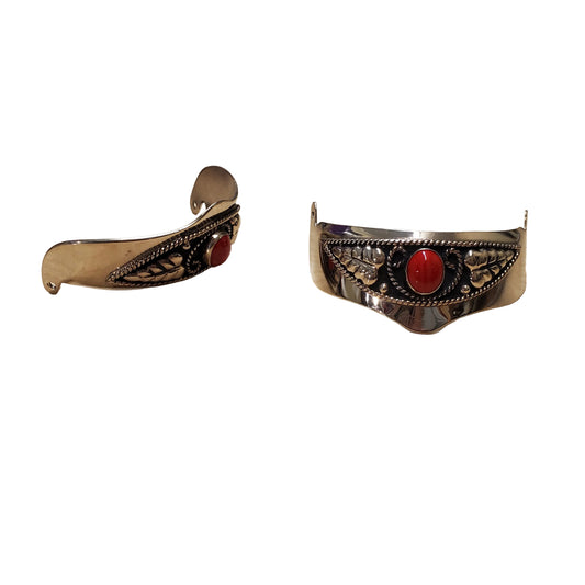 a pair of silver heel caps with red stones on a white background