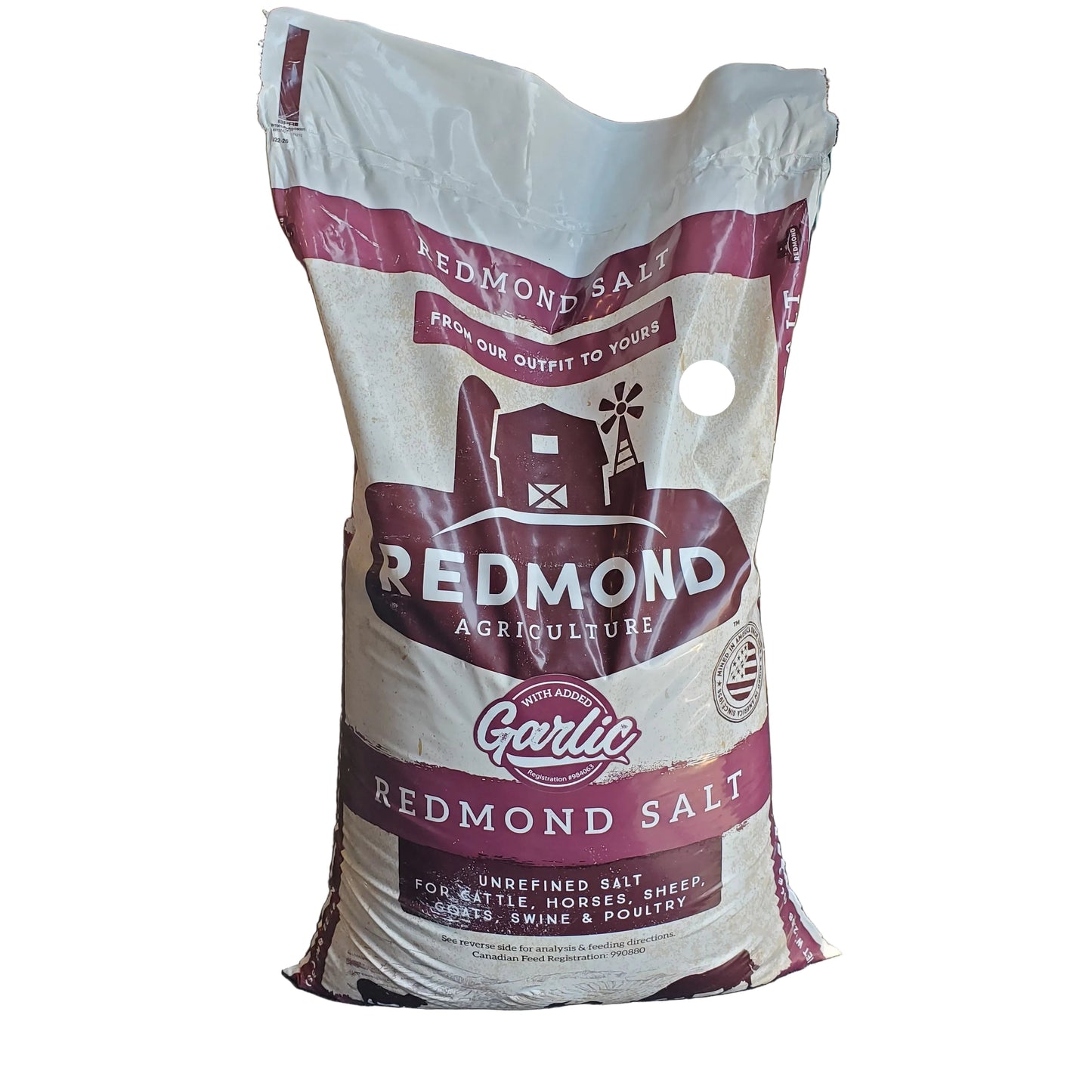 a red and tan bag of redmond salt with added garlic on a white background