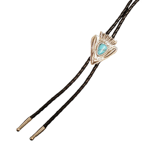 A close-up of a silver-toned bolo tie with a turquoise stone and textured feather-like detailing