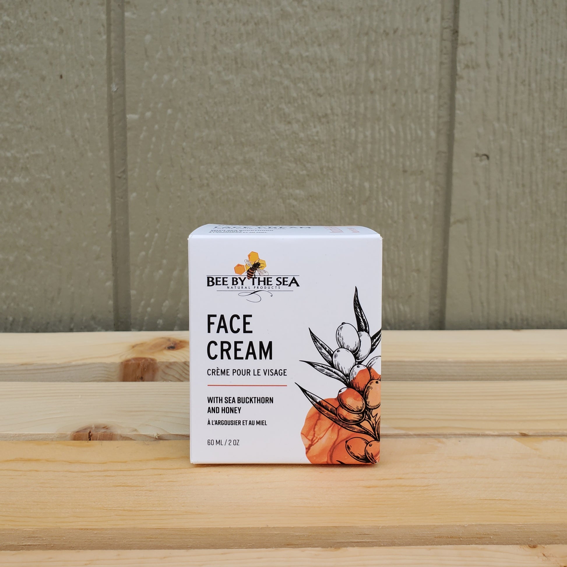 Box of Bee by the Sea Face Cream on a wooden surface with a neutral background