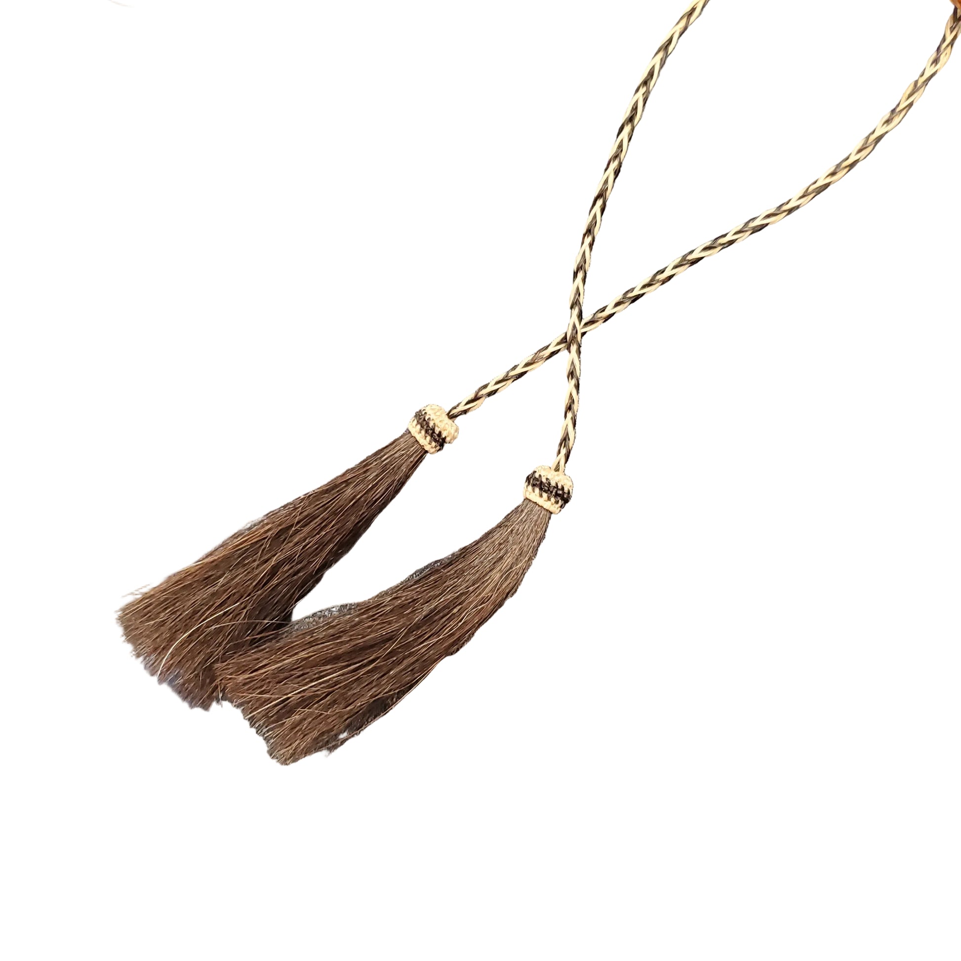 a close up of a horsehair stampede string on a white background
