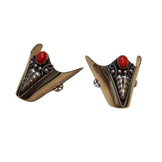 silver boot tips with red stone and overlay detail on a white background