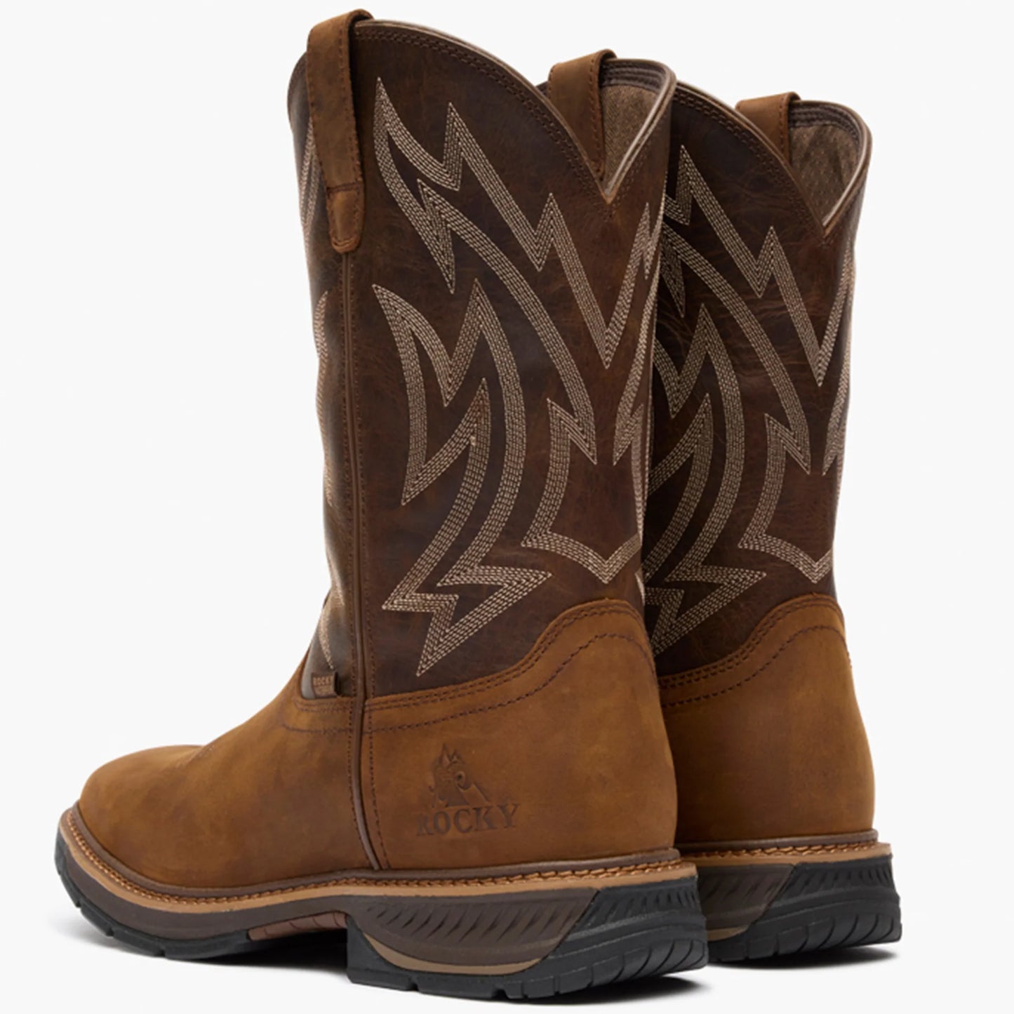 Pair of brown leather Rocky boots with decorative pattern on a white background