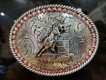 barrel racer and pink bling belt buckle on a black background