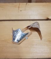 a pair of silver boot tips on a wooden background