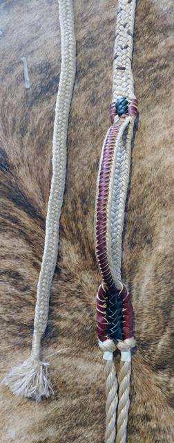 A close-up of a bull rope with a handle and a lace-up design, featuring poly knots which may change color.