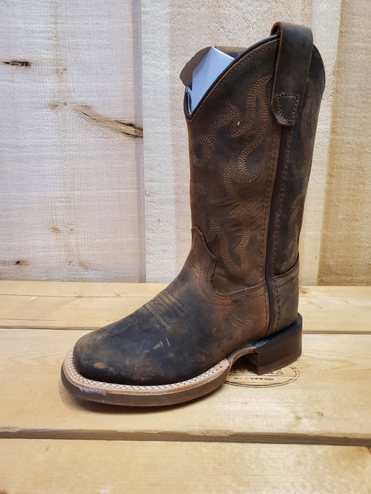 brown kids cowboy boot on a wooden background