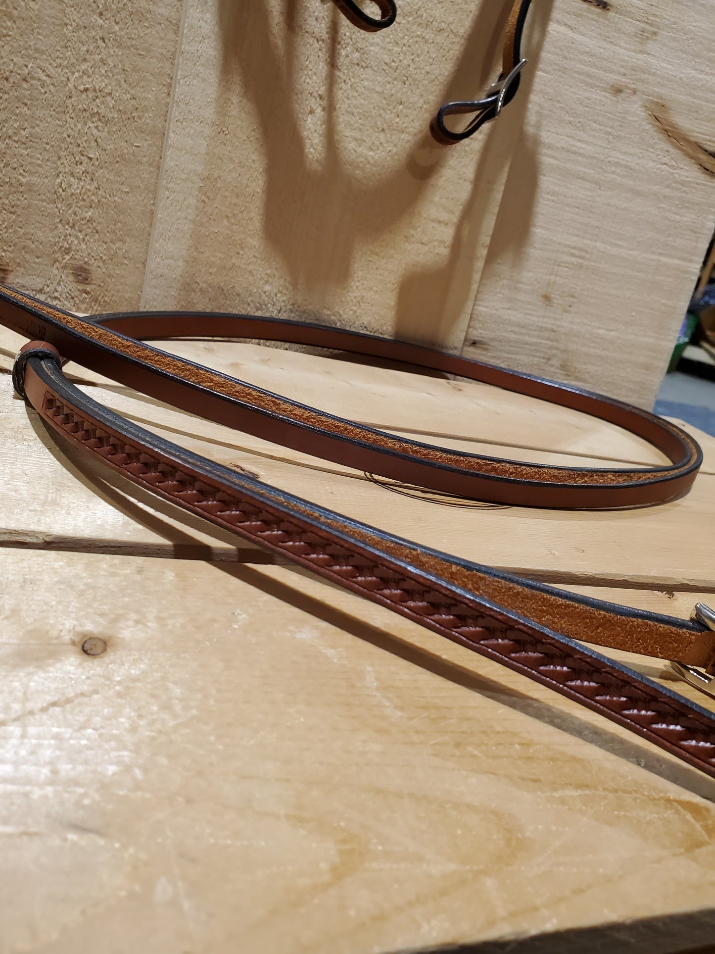 leather reins on a wooden background