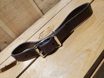 dark brown leather strap with a double bar roller buckle and a metal loop used as a breast collar tug for horse equipment