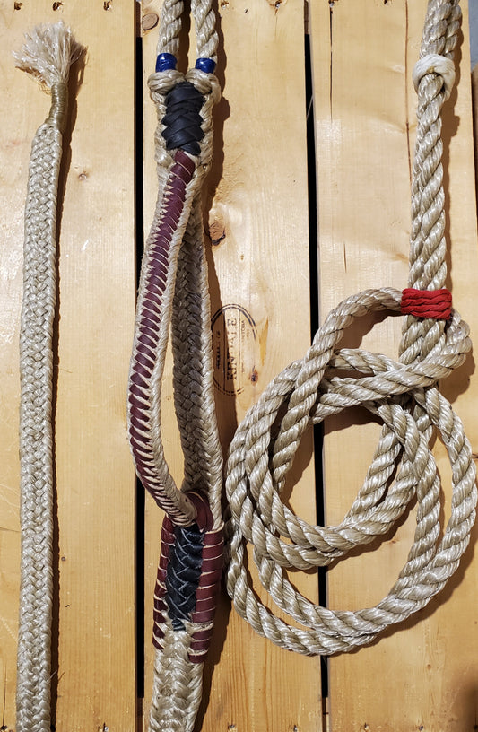 A braided bull ropes with varying colors displayed on a wooden surface.