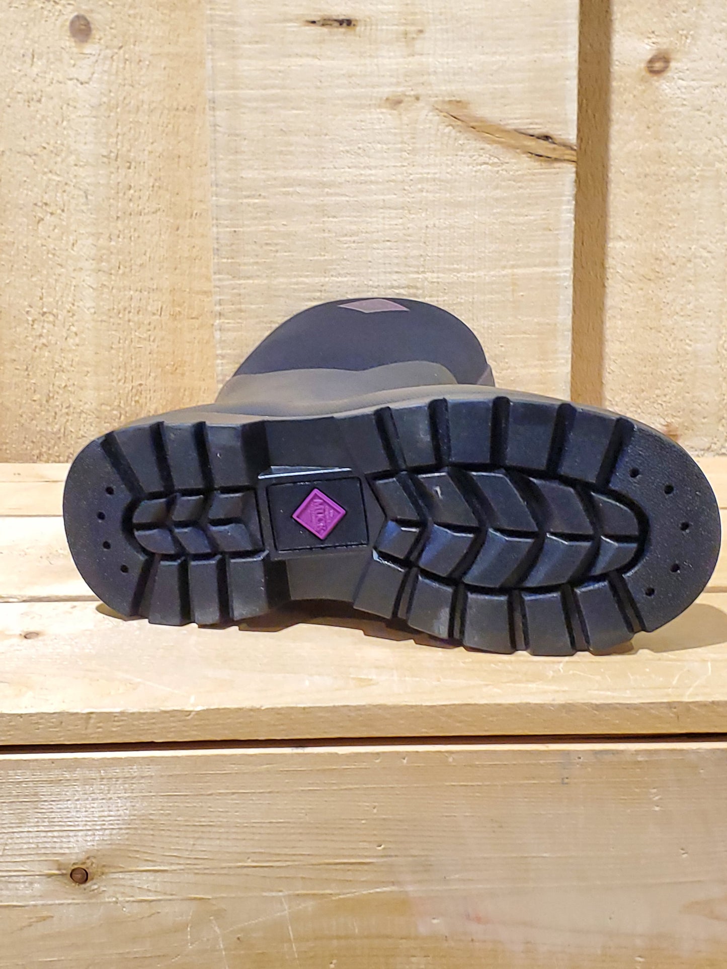 a close up of the outsole of a black rubber boot