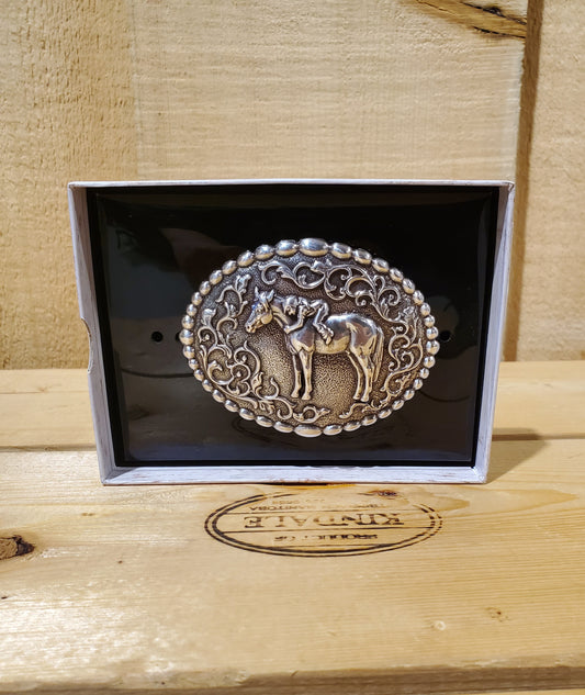 horse and girl belt buckle on a wooden background