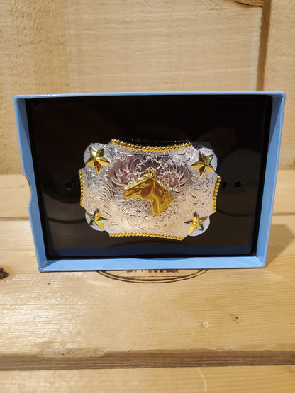 a gold and silver belt buckle in a display box with a horse head on it on a wooden background