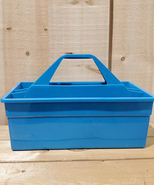 A blue plastic utility tote with a handle, designed to be carried by hand and to fit onto a fence board.
