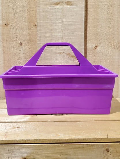 A purple plastic utility tote with a handle, designed to be carried by hand and to fit onto a fence board.