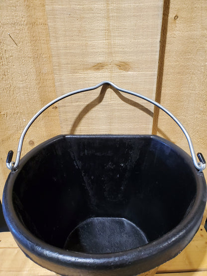 top view of a black rubber 18 qt bucket with handle on a wooden background