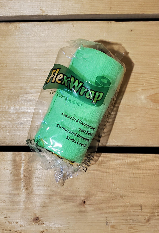 A rolled-up green FlexWrap E-Z Tear bandage, secured with a label that has the product name and details.