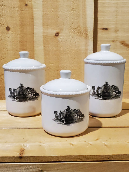 a set of three white ceramic canisters with a western themed black and white design