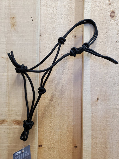 A black poly-nylon rope halter hanging against a wooden 