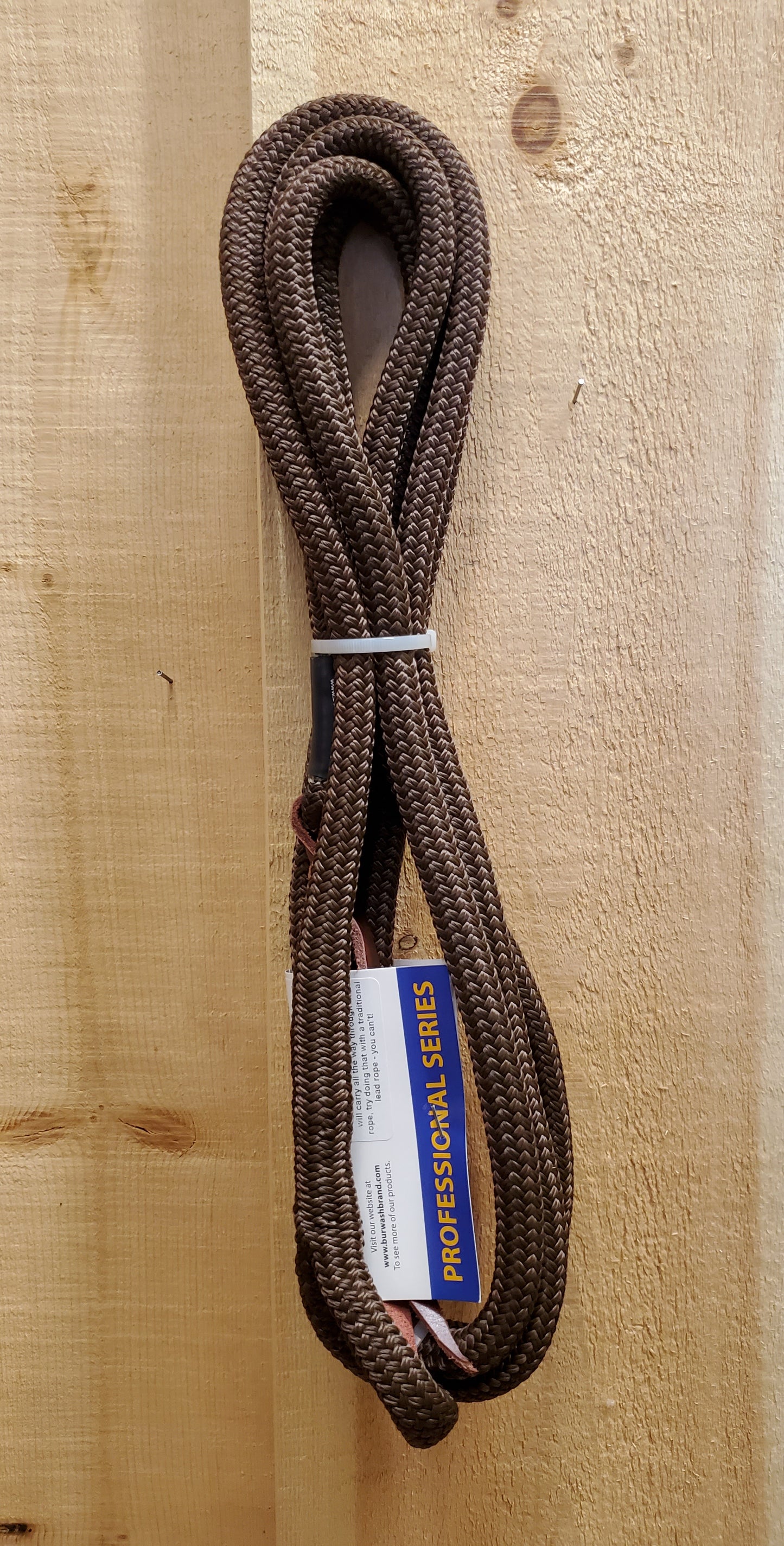 A 12-foot brown lead rope with a loop end and a leather popper on the end, displayed against a wooden background.