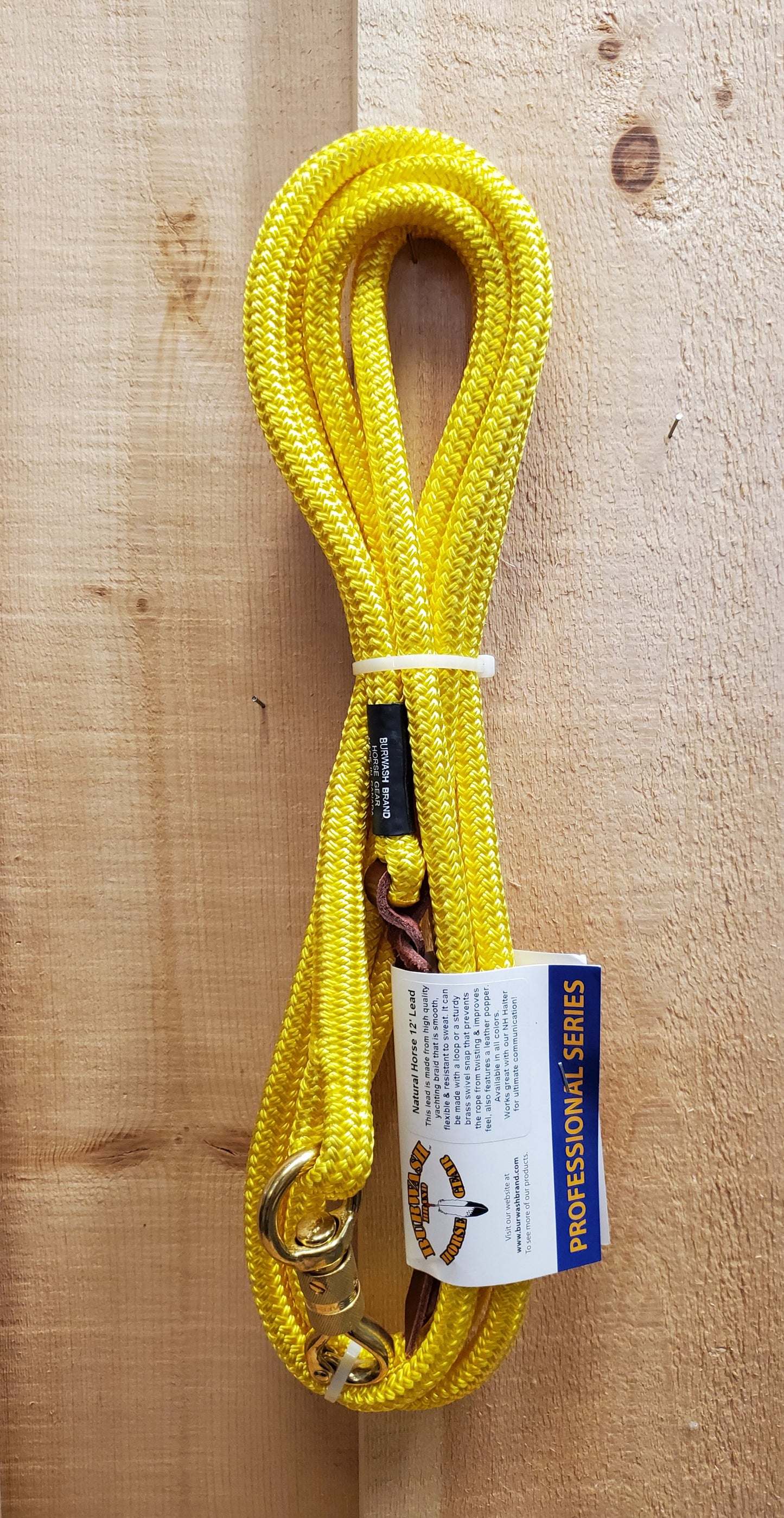 a yellow 12 foot lead rope with a brass swivel snap on a wooden background
