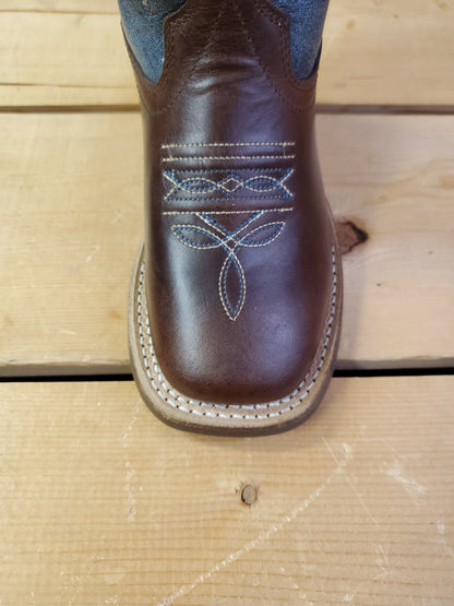 a close up of a square toe of a cowboy boot on a wooden background