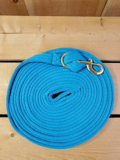 turquoise coiled up rope with a brass snap on a wooden background