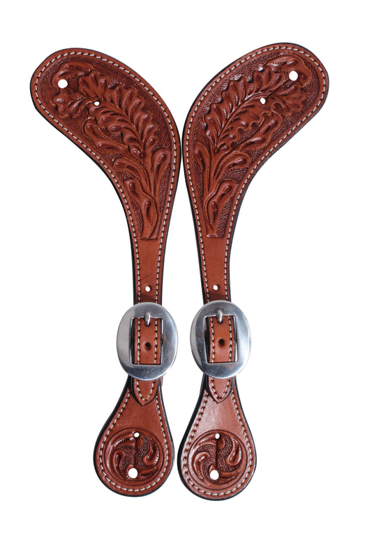 leather spur straps with an oak leaf pattern and stainless steel buckles on a white background